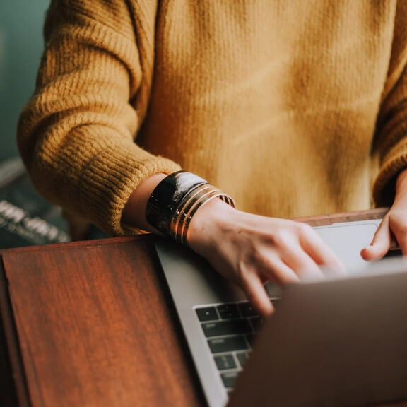 A woman typing at a computer